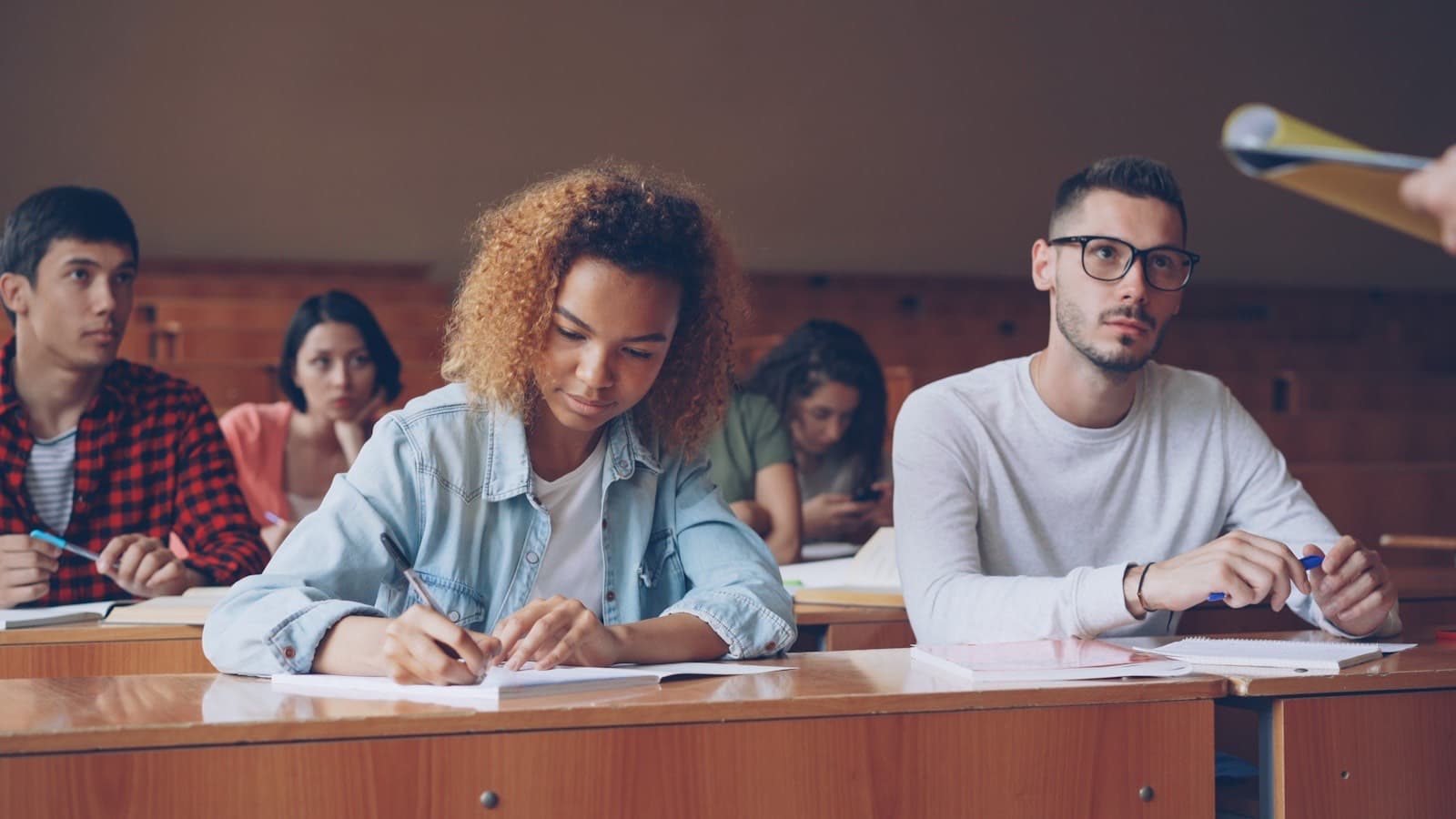 Adults in a training session taking notes